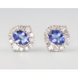 A pair of 18ct white gold oval tanzanite and diamond ear studs, the oval cut stones approx. 2.