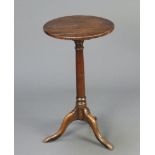 An 18th/19th Century circular oak wine table, raised on a turned column with tripod base 66cm h x