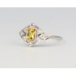 A platinum yellow sapphire and diamond ring, the sapphire 0.5ct, the diamonds 0.25ct, size N, 3.6
