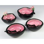 A 1960's ceramic dessert set comprising 4 bowls and 4 ceramic spoons with black exteriors and
