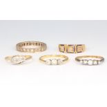 Four 18ct yellow gold gem set rings, size M, 10 grams and a yellow metal eternity ring 2 grams