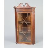 An Edwardian inlaid mahogany corner cabinet with pediment, moulded and dentil cornice, fitted