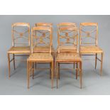 A set of 6 19th Century beech framed chairs with shaped mid rails and woven cane seats, raised on