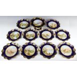 A Victorian dessert service with gilt and dark blue rims enclosing views comprising eight plates "