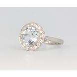 A platinum aquamarine and diamond cluster ring, the centre circular stone 2.5ct, the brilliant cut