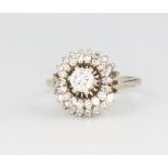 An 18ct white gold diamond cluster ring 4.1 grams, size M 1/2, the centre stone 0.4ct surrounded