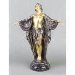 An Art Deco style bronze figure of a standing lady raised on a circular black marble socle base 40cm