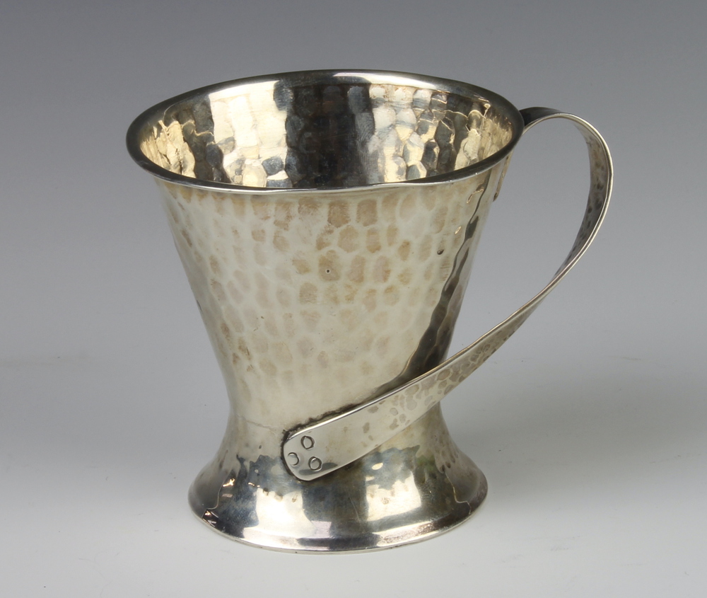 A Edwardian Arts and Crafts silver hammered pattern tapered mug with fancy handle London 1906 8cm,