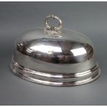 An Edwardian oval silver plated meat cover engraved with a crest 43cm Dented