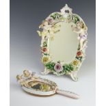 A 20th Century German porcelain easel mirror decorated with cherubs and encrusted flowers 31cm