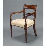 A 19th Century mahogany bar back carver chair with shaped mid rail and overstuffed seat, raised on