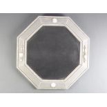 A 1920's octagonal bevelled plate wall mirror contained in an oak silver painted frame 55cm x 54cm