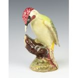 A Beswick Woodpecker, number 1218, standing on a stump 22cm