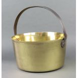 A 19th Century circular brass preserving pan with polished steel handle 38cm h x 33cm diam.