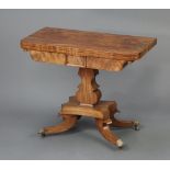 A William IV bleached mahogany D shaped card table raised on a shaped column and triform base ending