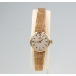 A lady's 9ct yellow gold Omega wristwatch contained in an 18mm case on a 9ct yellow gold mesh