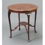 An Edwardian circular mahogany 2 tier occasional table raised on cabriole supports with plate