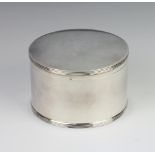 A circular silver box with hinged lid, London 1935, 11cm, 370 grams