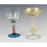 A 19th Century Italian glass with gilt scroll decoration and a panel painted a gentleman, raised
