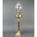 A Victorian circular faceted cut glass oil lamp reservoir raised on a brass Doric column with square