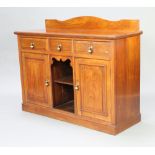 An Edwardian Art Nouveau walnut sideboard with raised back and 3 drawers above recess, flanked by