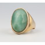 A yellow metal cabochon cut hardstone ring 9.9 grams gross, size P