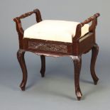 A Victorian carved mahogany box seat piano stool with hinged lid, raised on cabriole supports 62cm h