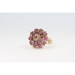 An 18ct yellow gold ruby cluster ring, size N 1/2, 7.3 grams,