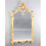 A 20th Century Rococo style mirror contained in a carved gilt wood frame 157cm x 88cm