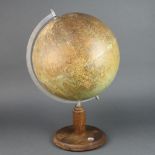 A unmarked 1950's terrestrial globe, raised on a turned oak base, the base fitted a compass 50cm h