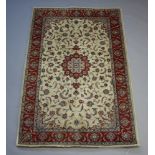 A Northwest Persian white and brown ground floral rug with central medallion within a 3 row border