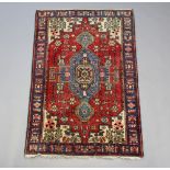 A blue, red and white ground Persian Navahand rug 199cm x 123cm Some flecking in places