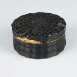 A good 19th Century circular turned tortoiseshell snuff box with gilt metal mounts, the lid interior