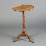 A 19th Century circular mahogany dish top wine table, raised on turned column and tripod base 70cm h