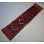 A red and blue ground Meshwani runner with 4 octagons to the centre 248cm x 60cm