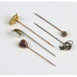 An Edwardian yellow metal tie pin in the form of a pig with ruby eyes, 4 other tie pins