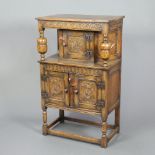 An Ipswich style carved oak court cupboard of small proportions, the upper section fitted a