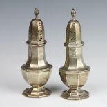 A pair of octagonal silver sugar shakers of Queen Anne style, Birmingham 1924, 18cm, 176 grams