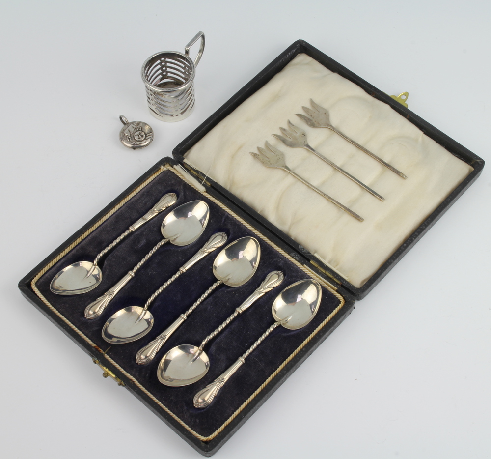 A set of 6 lily pattern silver coffee spoons, Birmingham 1925, 3 pickle forks, a rattle and a cup