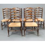A set of 6 17th Century style beech and elm ladder back dining chairs with woven rush seats