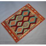 An orange, turquoise and brown ground Chobi Kilim rug with all-over diamond design 150cm x 106cm