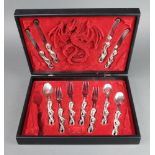 A set of steel cutlery with dragon handles comprising 4 dinner knives, 4 dinner forks and 3 spoons