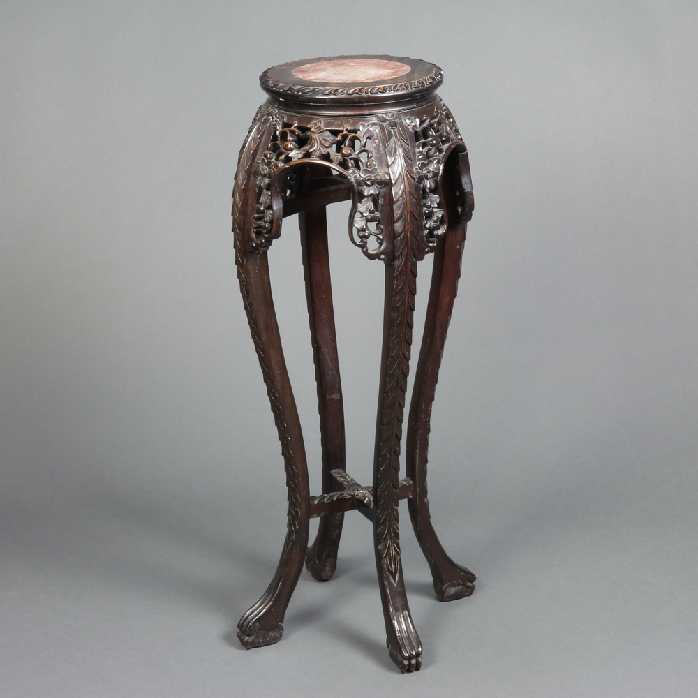 A 19th Century Chinese carved and pierced hardwood jardiniere stand with pink veined marble top,