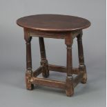 An oval oak occasional table, the bottom formed from a 17th/18th Century oak joined stool, raised on