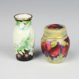 A Moorcroft enamelled vase and cover decorated with fruit 7cm together with an oviform vase