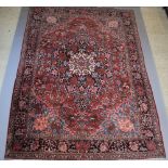 A red, blue and floral ground Northwest Persian carpet with central medallion within a 5 row