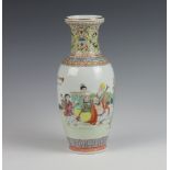 A 20th Century Chinese famille rose vase decorated with figures in a garden setting and script 25cm