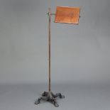 Carter Limited, an Edwardian mahogany brass and iron music/reading stand, raised on a brass pole