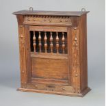 A 17th Century style Continental oak hanging cabinet/bread hutch with moulded and dentil cornice,