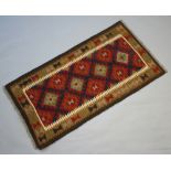 A black, red and tan ground Maimana Kilim rug with 4 diamonds to the centre 154cm x 80cm